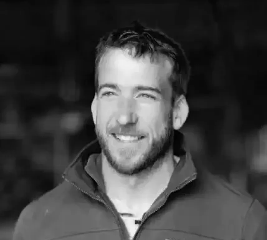 Profile-style portrait photograph of a person against a simple background.
